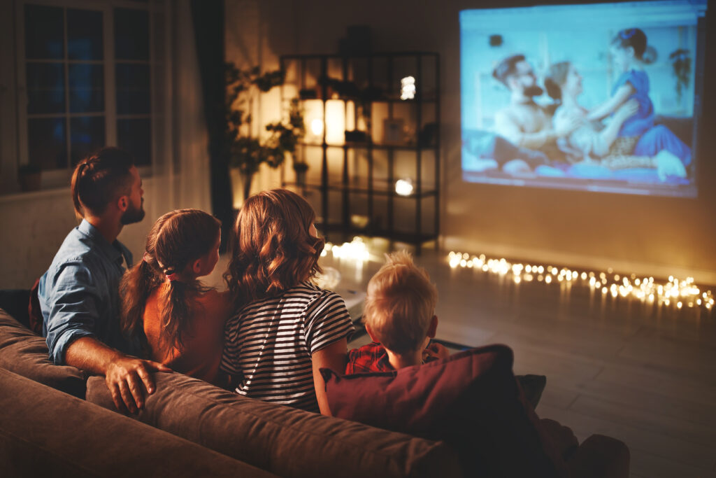 Picture of a home cinema room with people sitting on a couch watching