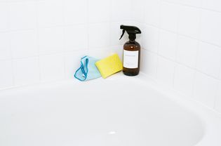 Clean refinished tub with cleaning supplies