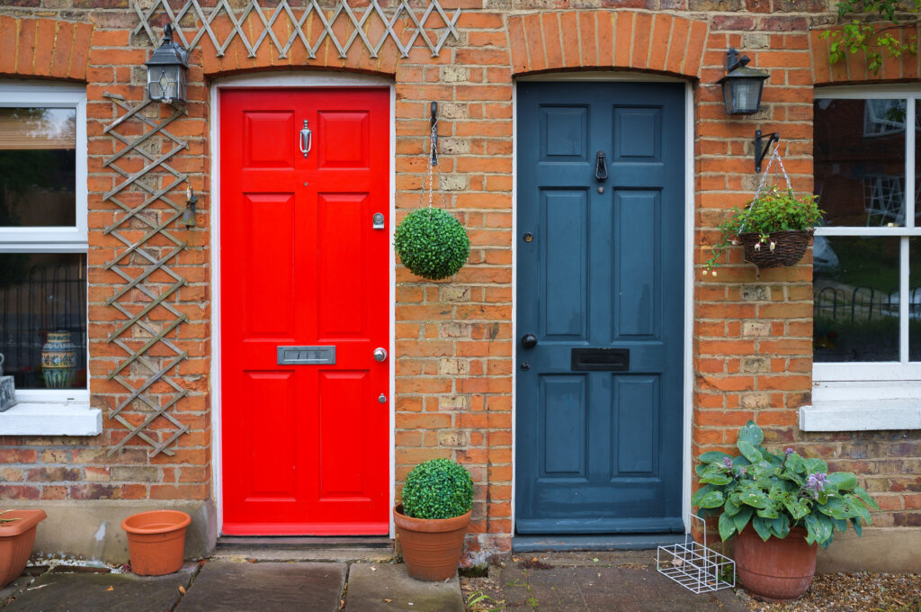 Picture of two front doors, one red one blue