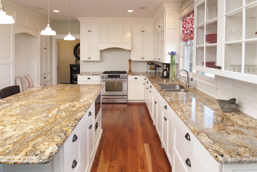 this spacious kitchen features marble counters and center counter, stunning hardwood cabinets and floor