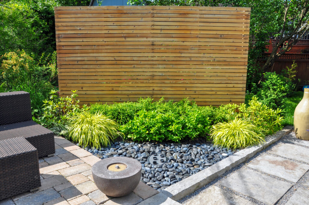 Picture of a garden with wooden panels acting as a privacy screen