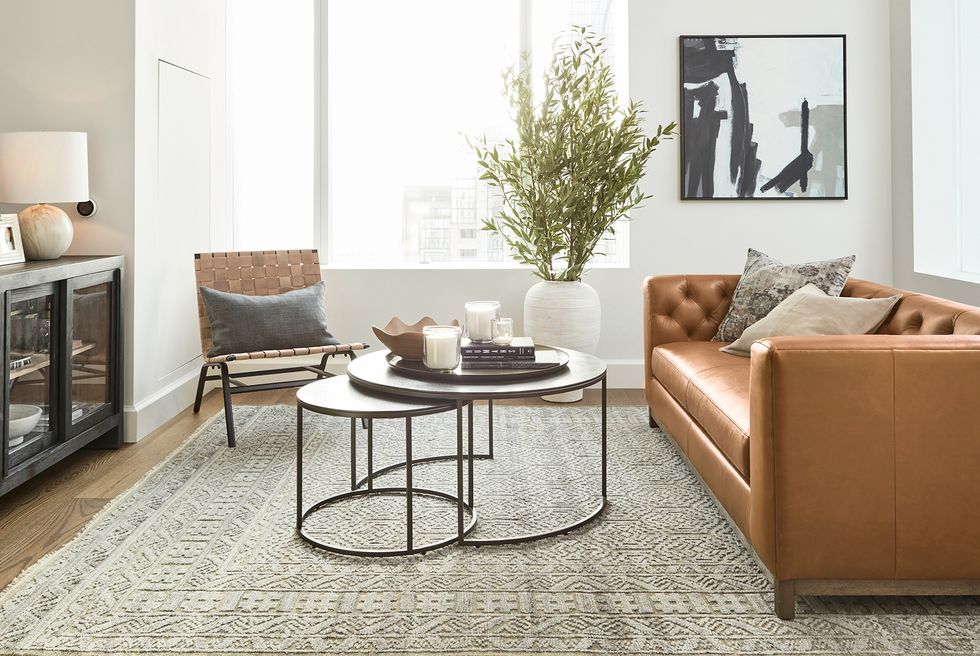 ayesha curry home tour lounge with leather couch and nesting tables