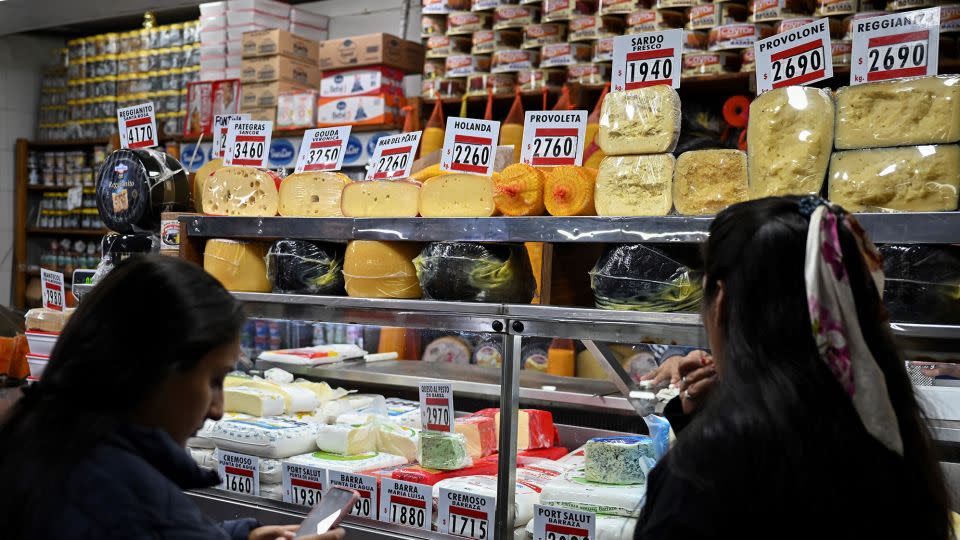 Women buy cheese in a stall at the Central Market in Buenos Aires, on May 12, 2023. - Luis Robayo/AFP/Getty Images