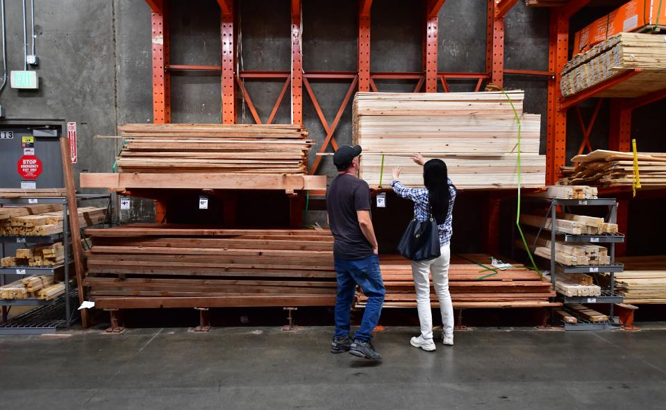 People shop for lumber at a Home Depot store in Alhambra, California.