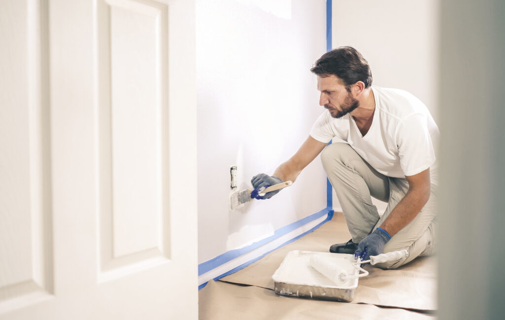 Picture of a painter and decorator painting a wall