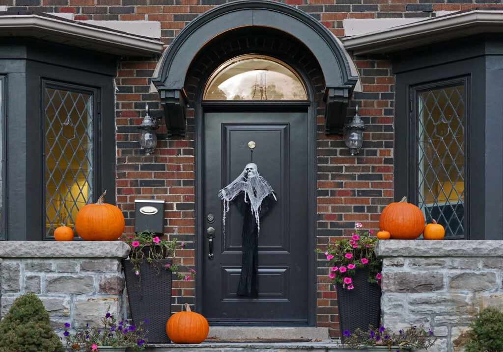 Front door decorated with halloween decorations