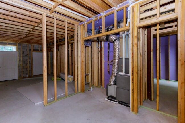 Wooden framing marks the beginning of a basement remodel.