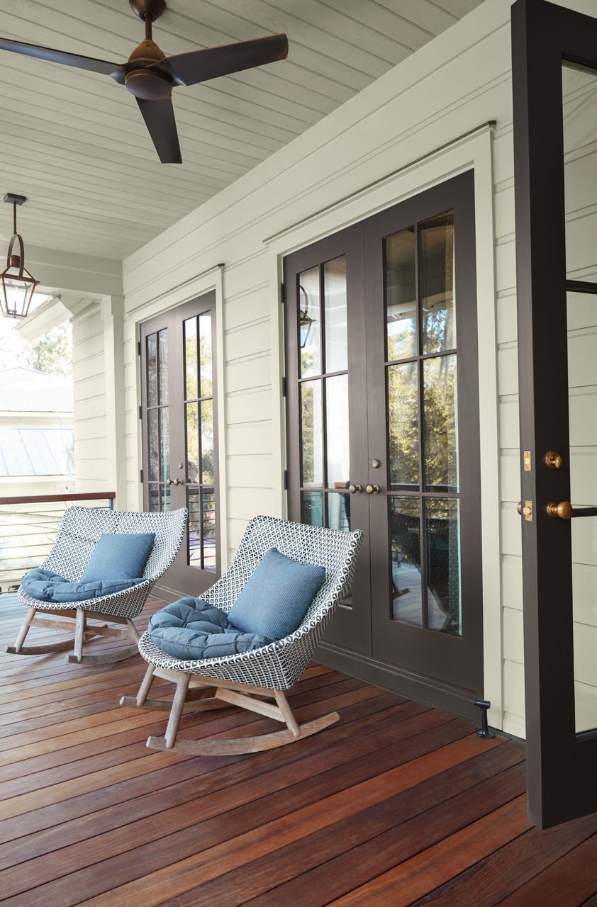 a deck with a wood floor and rocking chairs